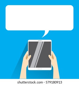 Hands holing white tablet computer with blank speech bubble for text. Text messaging flat design concept. 