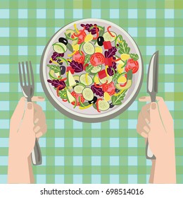 Hands with a knife and fork near a plate of vegetables salad on Salad bowl. Healthy fresh food in a plate and vegetables on a table cloth background. 