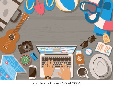 Hands of man planning trip on laptop with summer vacation elements on wooden table from top view in flat style