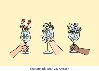 Hands of multiracial people hold wineglasses with flowers inside. Creative blossom plant arrangement in glassware for interior, party. Floral drink, lemonade, cocktail in wine glasses vector concept.