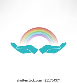 hands on background of the colorful rainbow