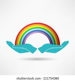 hands on background of the colorful rainbow