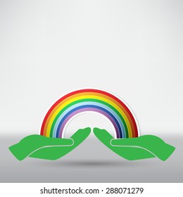 hands on background of the colorful rainbow