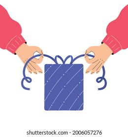 Hands packing a Christmas gift box. The concept of preparing for the winter holidays. Self-packing of gifts