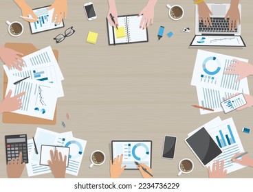 Hands of people with variety of skin tones, actions and devices around wooden table for business meeting concept from top view