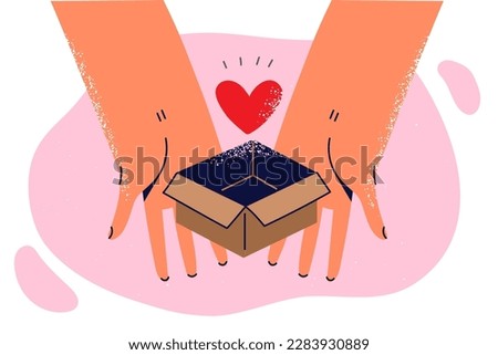 Hands of person with heart in giftbox symbolizing present from loved one for Valentines Day or anniversary of dating. Cardboard box with heart for charity and healthcare donation concept 
