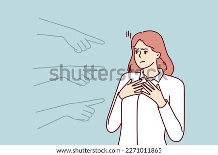 Hands pointing at puzzled girl for concept blame and condemnation person who made mistake. Unhappy girl suffers from unreasonable blame of colleagues or friends motivated by hatred or discrimination