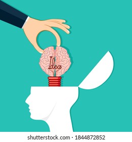 Hands put the brain bulb in the human head. Creative change