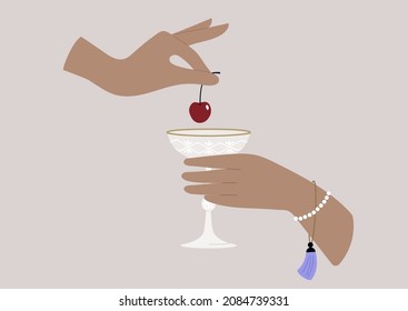Hands putting a cherry in a champagne glass, upper-class lifestyle
