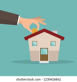 Hands putting coin wiht new house