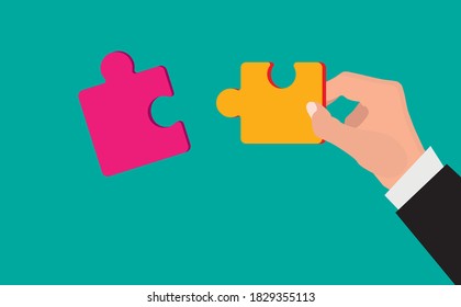 Hands putting puzzle pieces. Teamwork business concept.