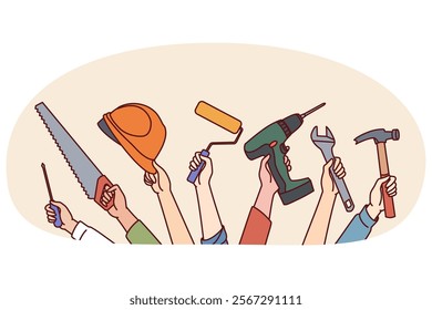 Hands of repair and construction specialists with working tools for safe and efficient work. Screwdriver and hammer with safety helmet in hands of furniture repair or building construction workers