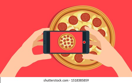 hands with smartphone shooting a pepperoni pizza. food blogger take a photo to social media