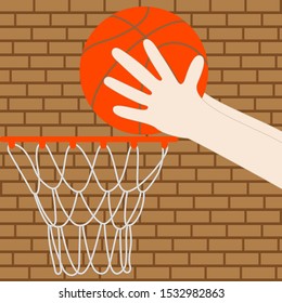 Hands throw a basketball in a ring on a brick wall background