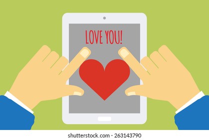 Hands touch device with heart on the screen