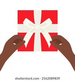 Hands untie a bow from the white ribbon on the red gift box