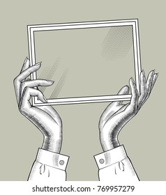 Hands of woman holding a rectangular frame with glass. Vintage engraving stylized drawing. Retro concept poster and banner. Vector illustration