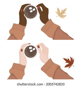 The hands of a woman in a sweater hold a coffee cup