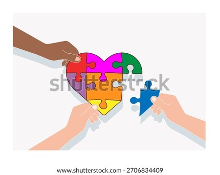 Hands working together to assemble a heart from puzzles