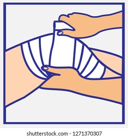 Person’s hands wrapping a bandage on an injured knee