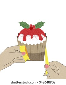Hands wrapping cupcake for Christmas