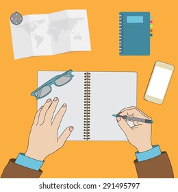 Hands writing on blank notebook