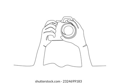 Hand-set camera shooting. World photography day one-line drawing