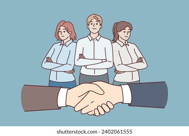 Handshake of business people during negotiations or making deal and office employees standing with crossed arms. Successfully completed business meeting with team providing consulting services