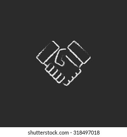 Handshake hand drawn in chalk on a blackboard vector white icon isolated on a black background.