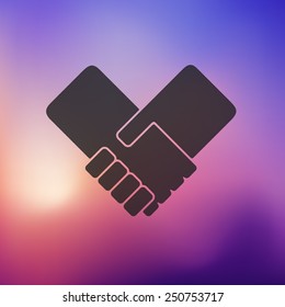 handshake icon on blurred background