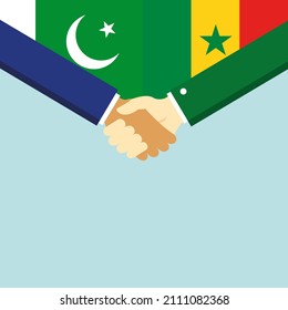 El apretón de manos y dos banderas: Pakistán y Senegal. Ilustración