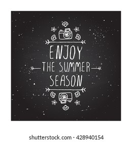 Hand-sketched summer element with camera, shell and starfish on blackboard background. Text - Enjoy the summer season