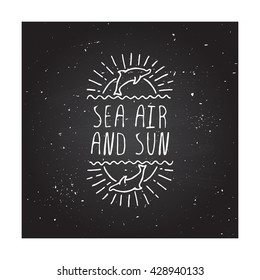 Hand-sketched summer element with dolphin and sun on blackboard background. Text - Sea air and sun