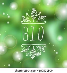 Hand-sketched typographic element. Bio - product label on blurred background. Suitable for ads, signboards, packaging and identity and web designs.