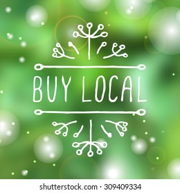 Hand-sketched typographic element. Buy local - product label on blurred background. Suitable for ads, signboards, packaging and identity and web designs.