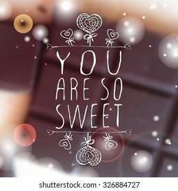 Hand-sketched typographic element  with doodle heart shaped lollipops on blurred background. You are so sweet.