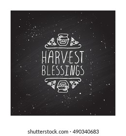 Hand-sketched typographic element with jam, berries and text on blackboard background. Harvest blessings