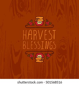 Hand-sketched typographic element with jam, berries and text on wooden background. Harvest blessings