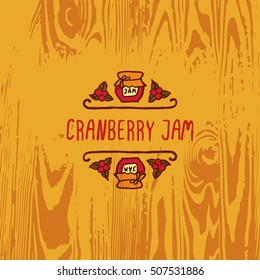 Hand-sketched typographic element with jam, berries and text on wooden background. Cranberry jam