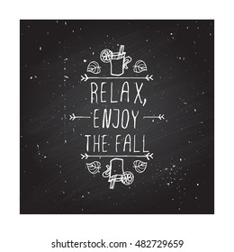 Hand-sketched typographic element with mulled wine, leaves and text on blackboard background. Relax enjoy the fall