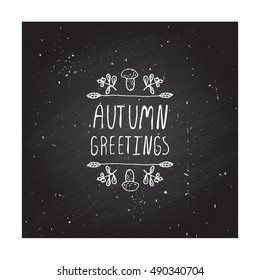 Hand-sketched typographic element with mushroom, berries and text on chalkboard background. Autumn greetings