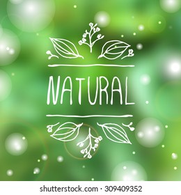 Hand-sketched typographic element. Natural product label on blurred background. Suitable for ads, signboards, packaging and identity and web designs.