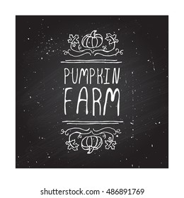 Hand-sketched typographic element with pumpkin, maple leaves and text on blackboard background. Pumpkin farm