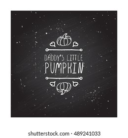 Hand-sketched typographic element with pumpkin, maple leaves and text on blackboard background. Daddy's little pumpkin