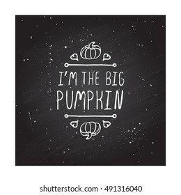 Hand-sketched typographic element with pumpkin, maple leaves and text on blackboard background.