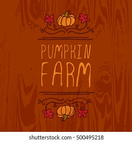 Hand-sketched typographic element with pumpkin, maple leaves and text on wooden background. Pumpkin farm