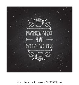 Hand-sketched typographic element with pumpkins, hearts, pumpkin spice latte and text on blackboard background. Pumpkin spice and everything nice