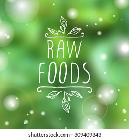 Hand-sketched typographic element.   Raw foods - product label on blurred background. Suitable for ads, signboards, packaging and identity and web designs.