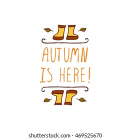Hand-sketched typographic element with rubber boots, leaves and text on white background. Autumn is here