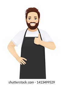 Handsome man in black apron standing showing thumb up isolated vector illustration